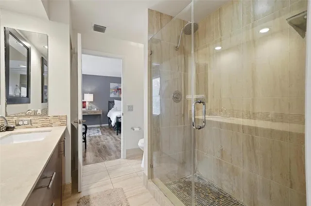 a bathroom with a shower sink and mirror