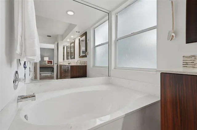 a spacious bathroom with a bathtub and a shower