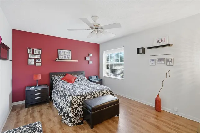 a bedroom with a bed and wooden floor