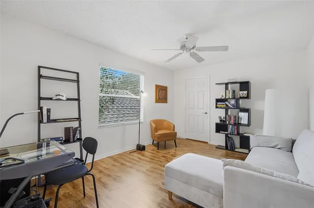 a view of a workspace with furniture and a window