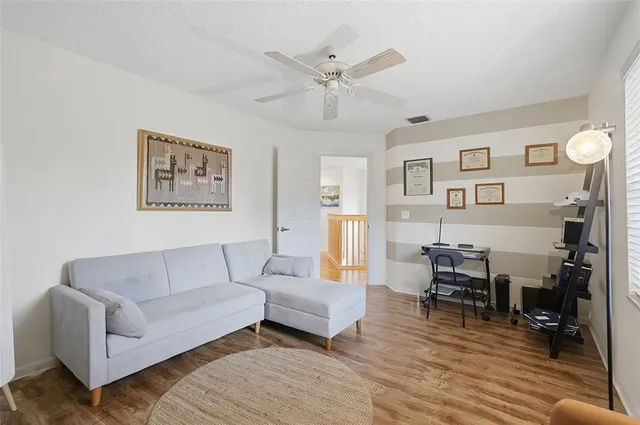 a living room with furniture and wooden floor