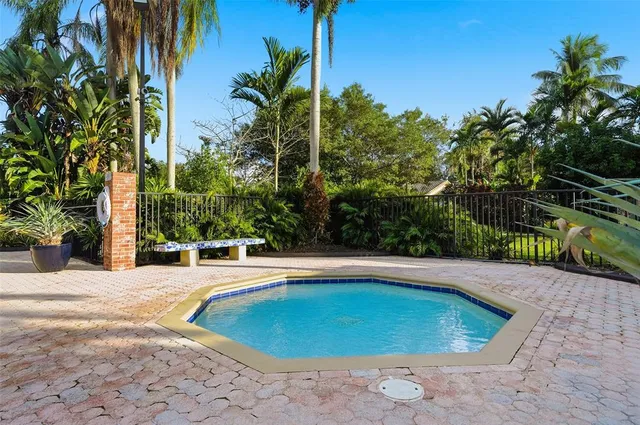 a swimming pool with trees in the background