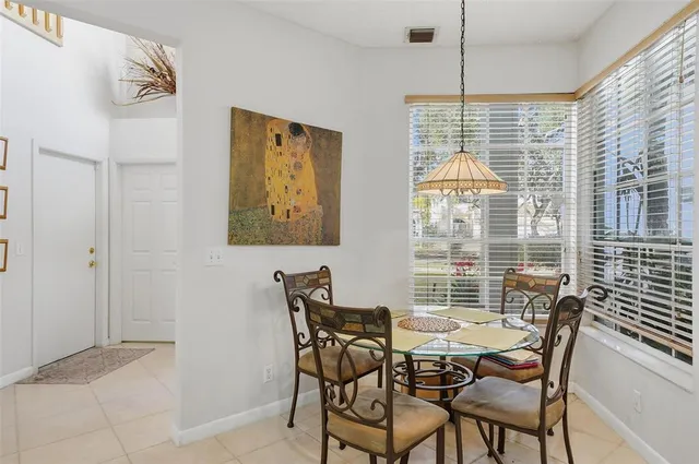 a view of a dining room with furniture and windows
