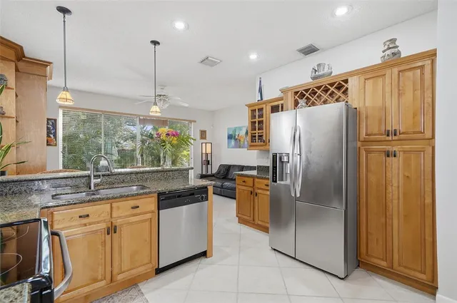 a kitchen with kitchen island granite countertop cabinets and stainless steel appliances