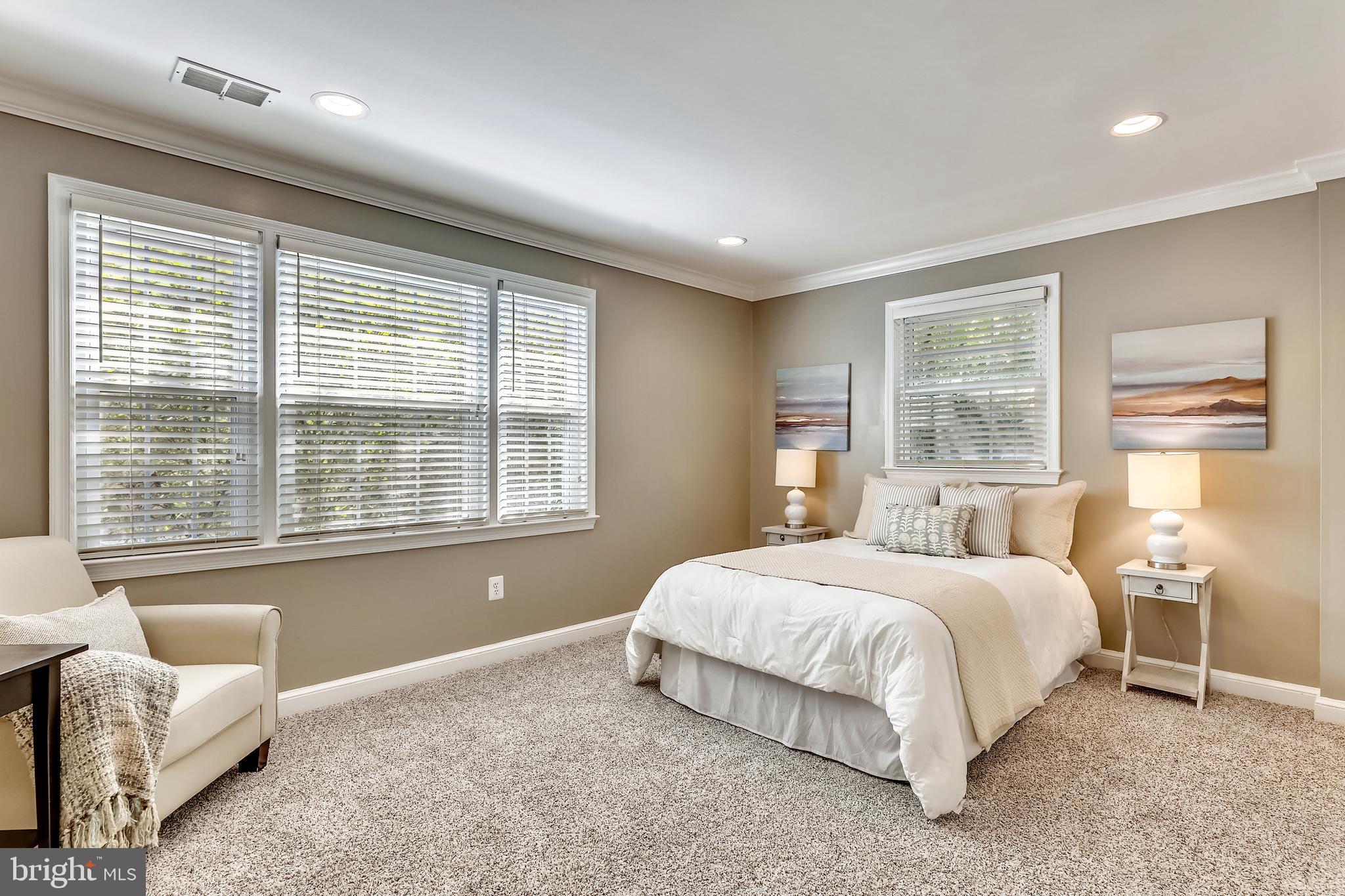 1007 West Braddock Road Alexandria, VA 22302 - Photo 22 of 55 a bedroom with a bed and a couch with outer view