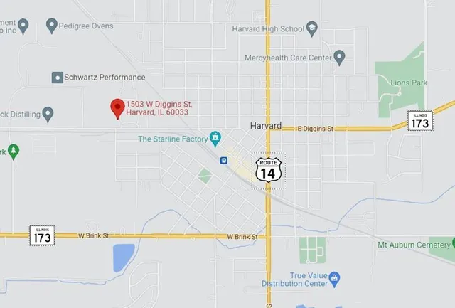 a utility room with a refrigerator and a car