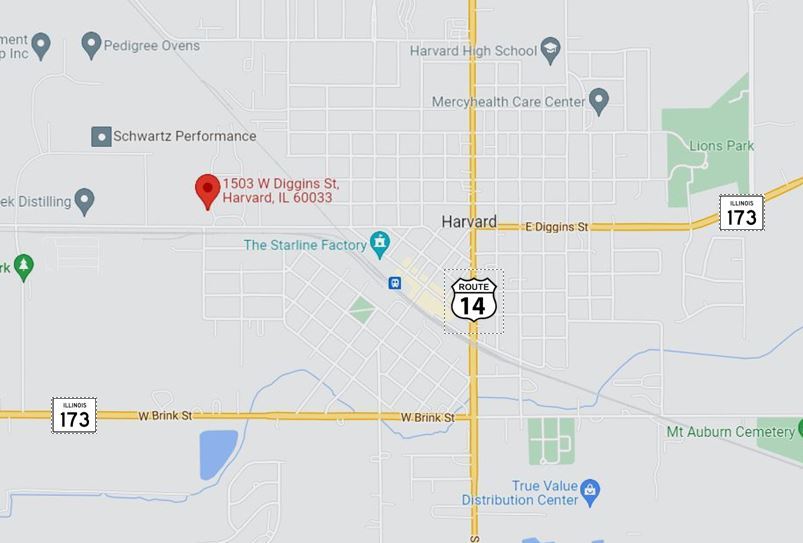 1503 West Diggins Street Harvard, IL 60033 - Photo 2 of 2 a utility room with a refrigerator and a car