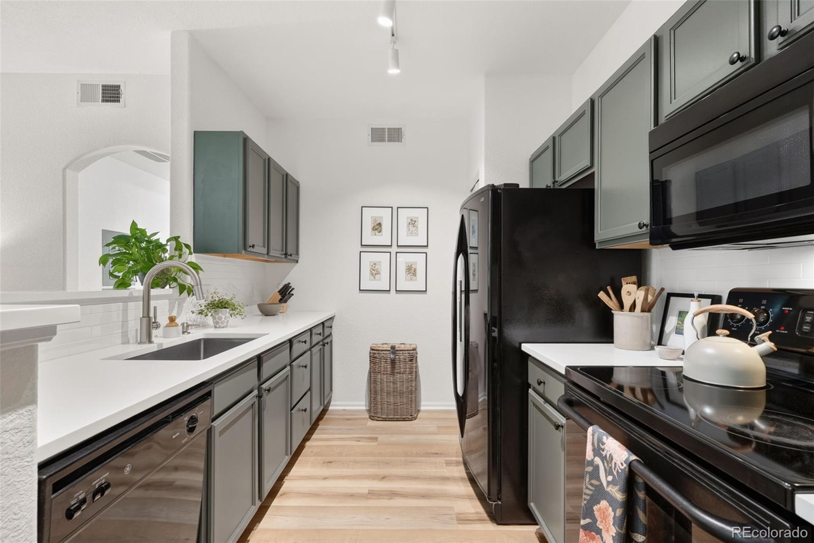 10733 Twenty Mile Road, Unit 208 Parker, CO 80134 - Photo 11 of 42 a kitchen with stainless steel appliances a sink stove and refrigerator