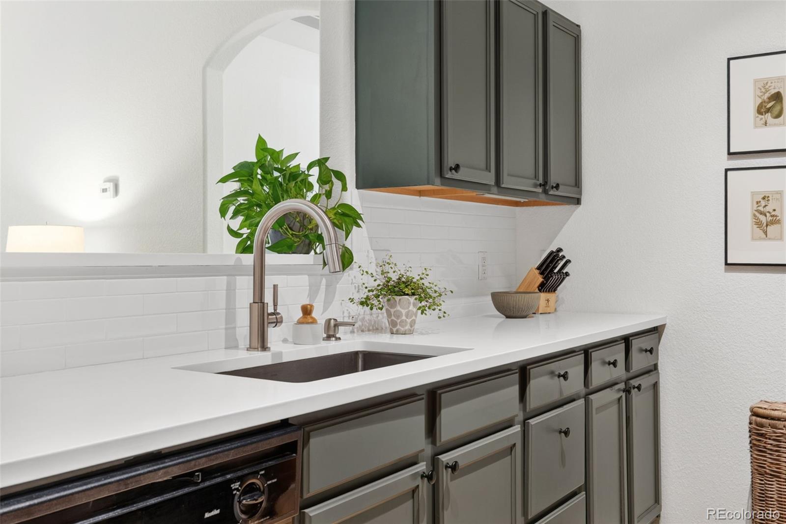 10733 Twenty Mile Road, Unit 208 Parker, CO 80134 - Photo 12 of 42 a kitchen with a sink and cabinets
