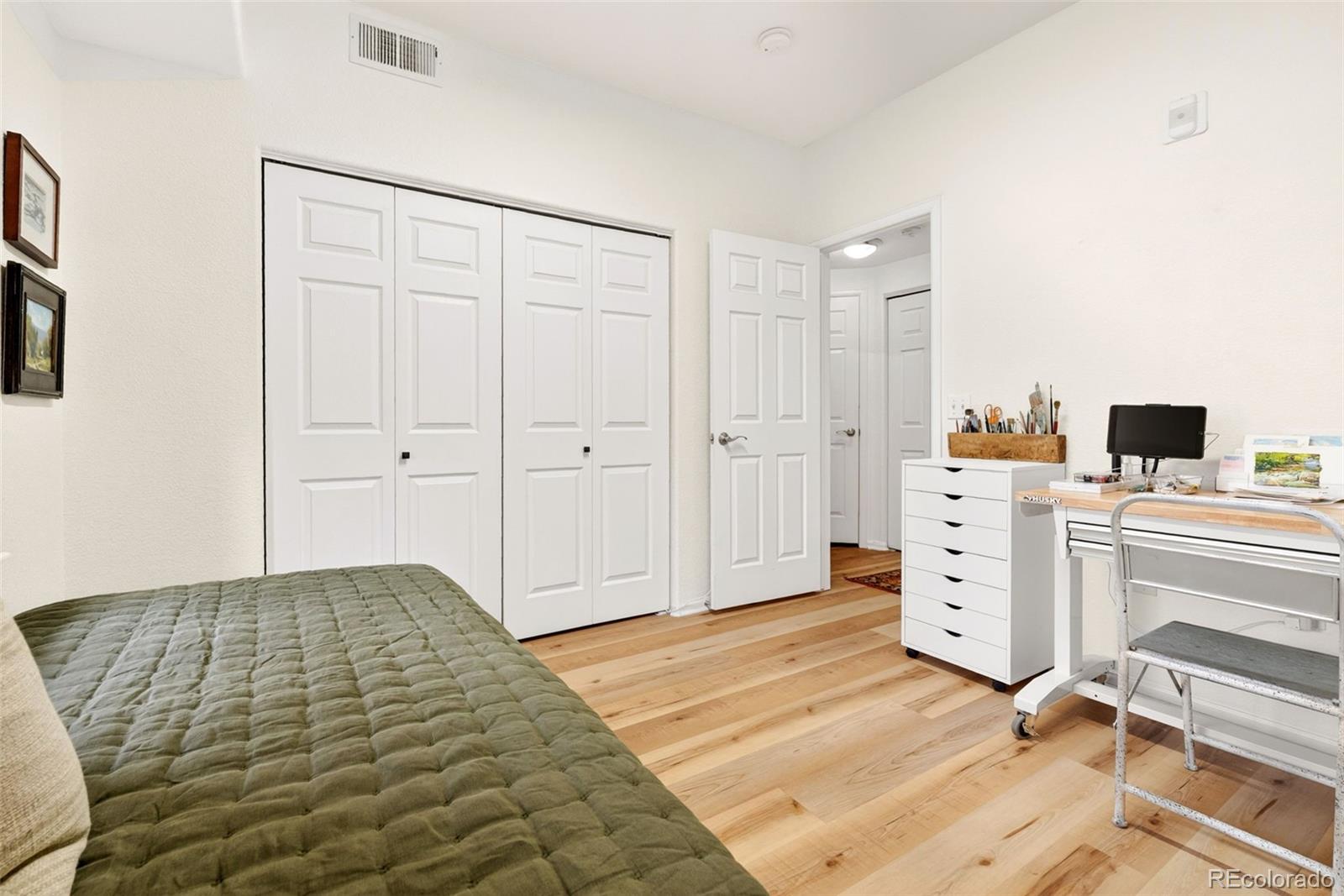 10733 Twenty Mile Road, Unit 208 Parker, CO 80134 - Photo 21 of 42 a bedroom with a bed and cabinets