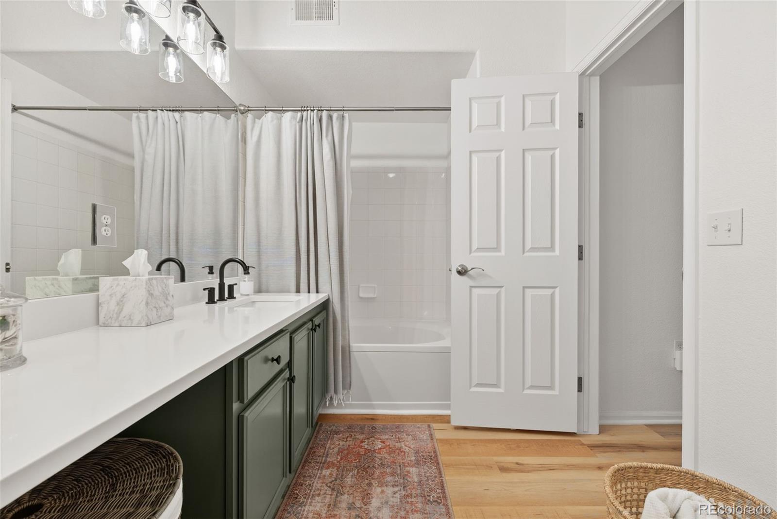 10733 Twenty Mile Road, Unit 208 Parker, CO 80134 - Photo 23 of 42 a bathroom with a double vanity sink and a mirror