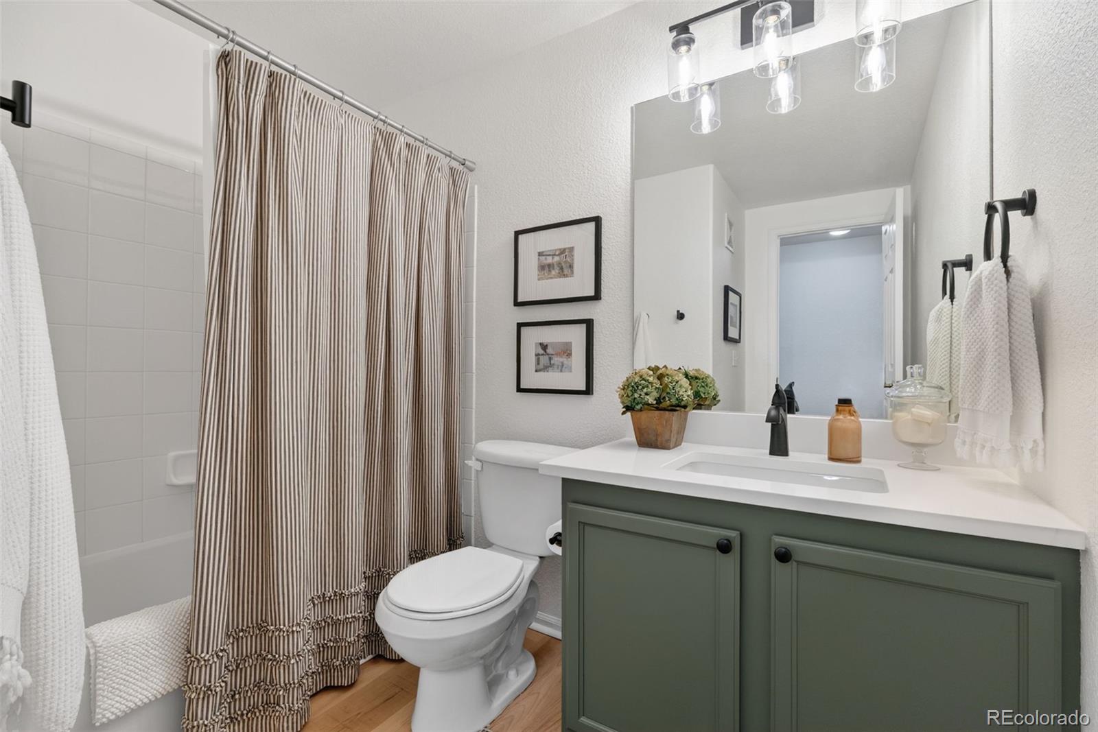 10733 Twenty Mile Road, Unit 208 Parker, CO 80134 - Photo 25 of 42 a bathroom with a sink a toilet and shower