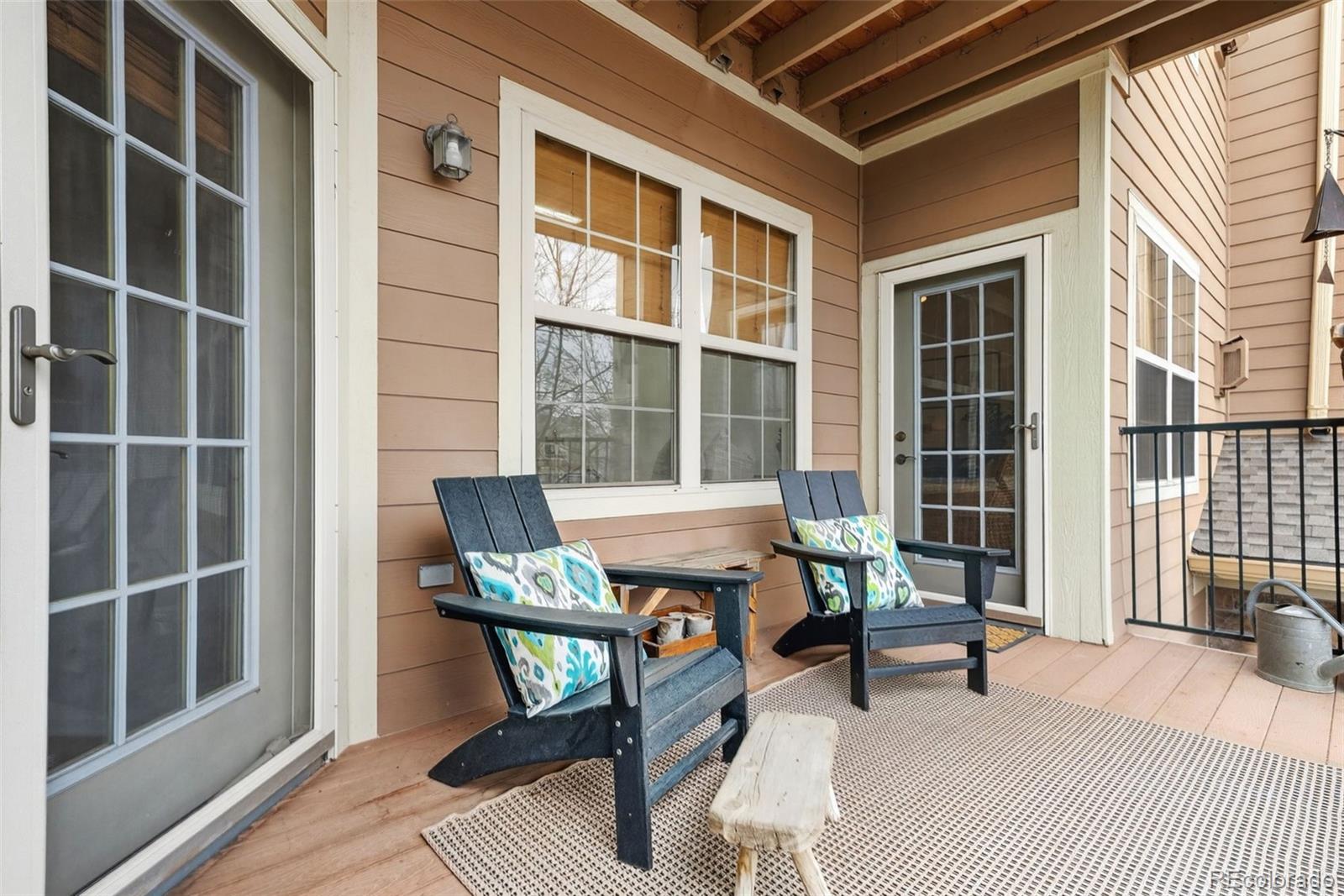 10733 Twenty Mile Road, Unit 208 Parker, CO 80134 - Photo 32 of 42 a building outdoor space with patio furniture and wooden floor