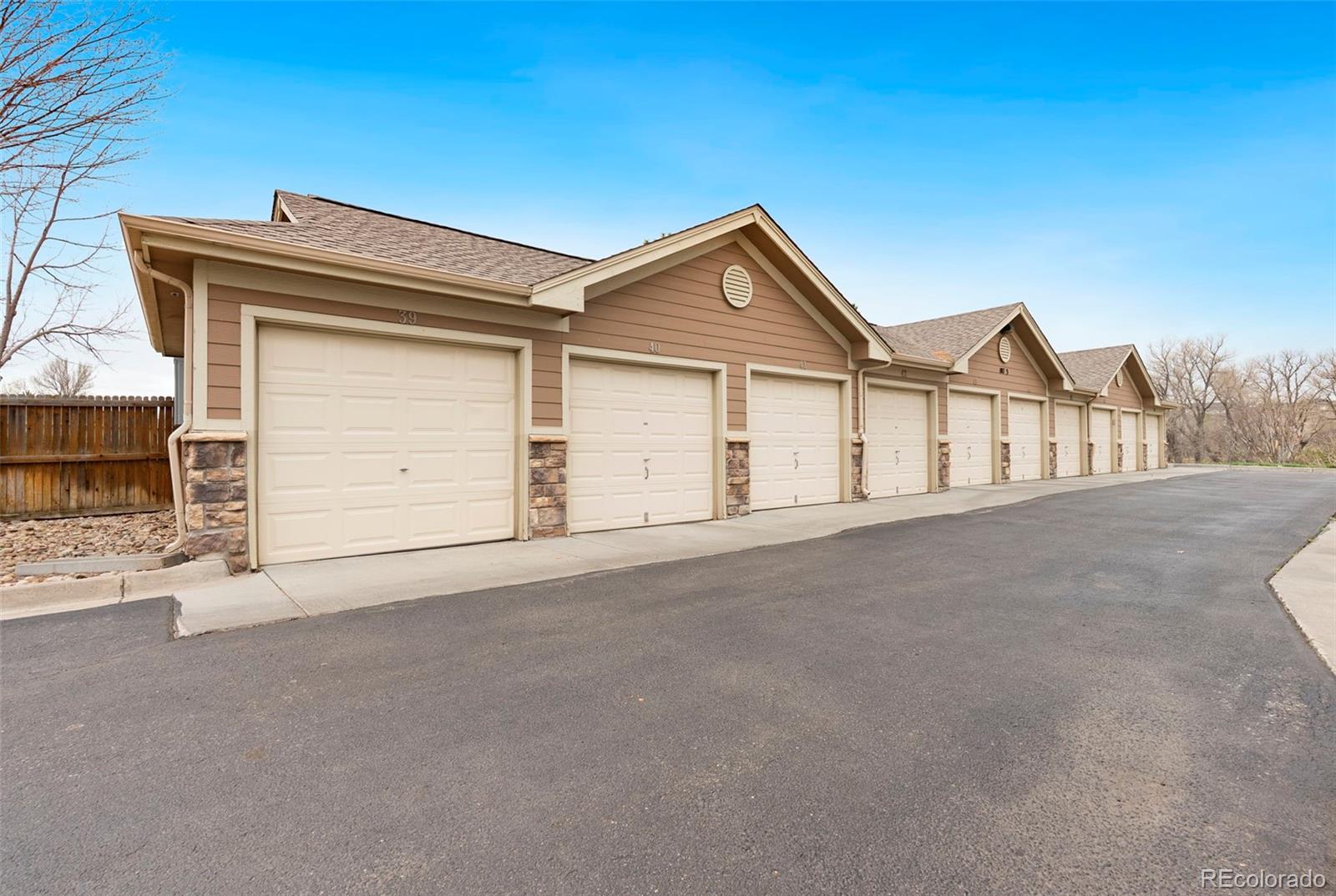 10733 Twenty Mile Road, Unit 208 Parker, CO 80134 - Photo 38 of 42 a view of a house with a garage