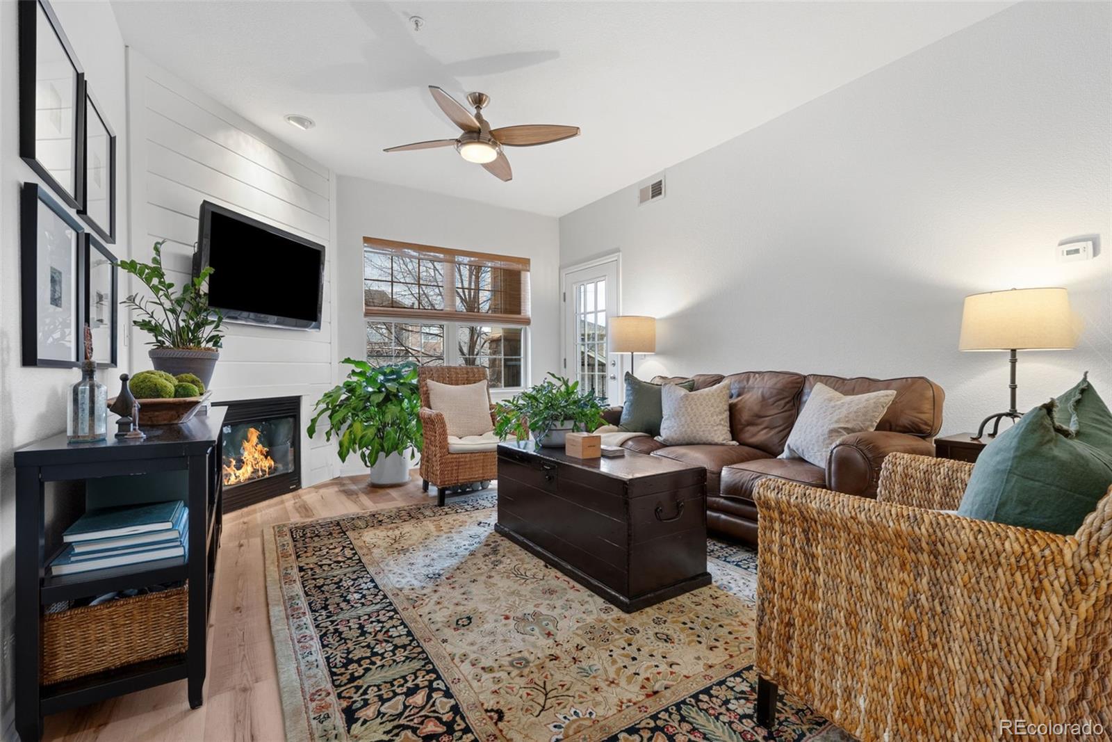 10733 Twenty Mile Road, Unit 208 Parker, CO 80134 - Photo 4 of 42 a living room with furniture a flat screen tv and a fireplace