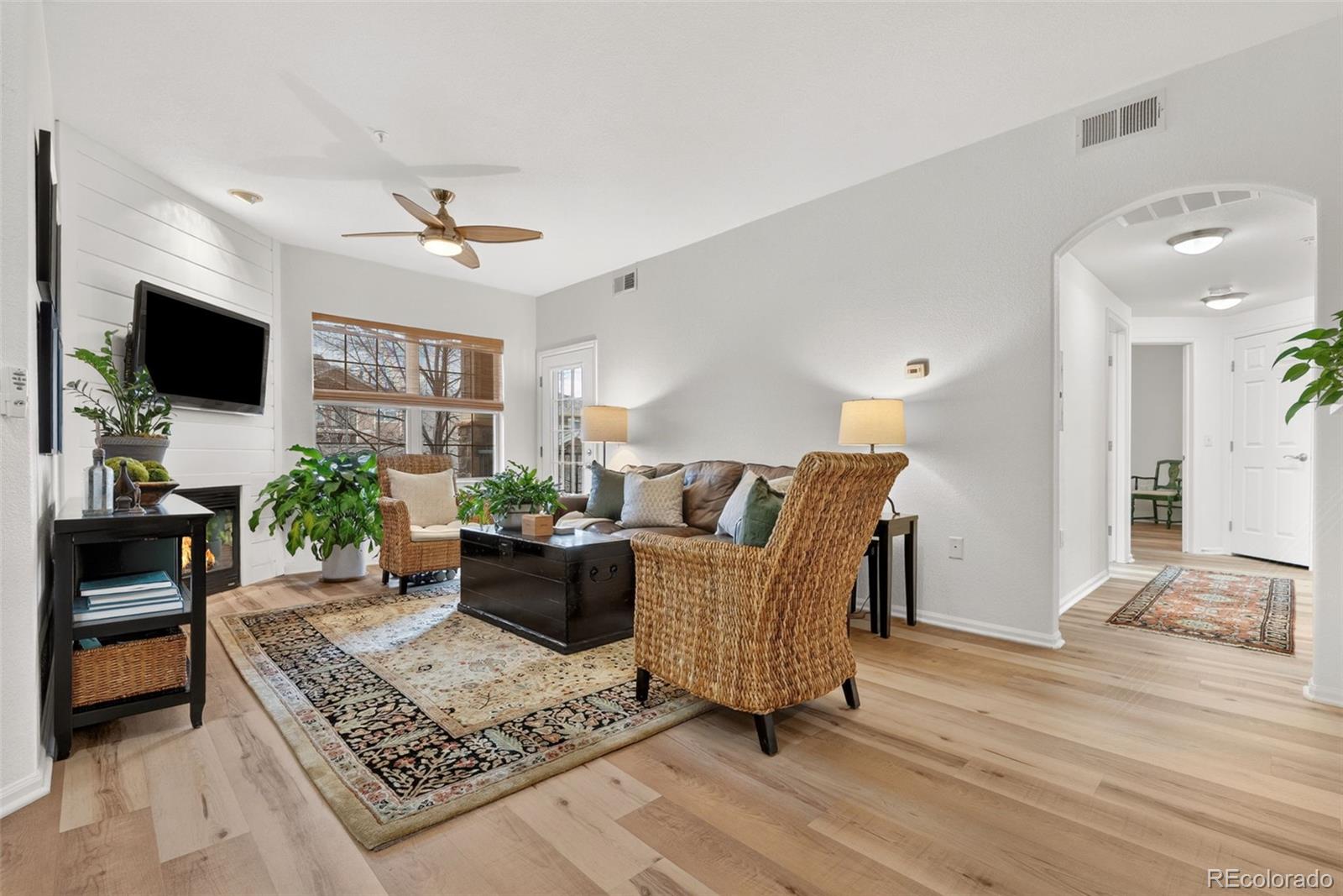 10733 Twenty Mile Road, Unit 208 Parker, CO 80134 - Photo 5 of 42 a living room with furniture a flat screen tv and a rug