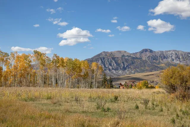 a view of a dry yard with mountains