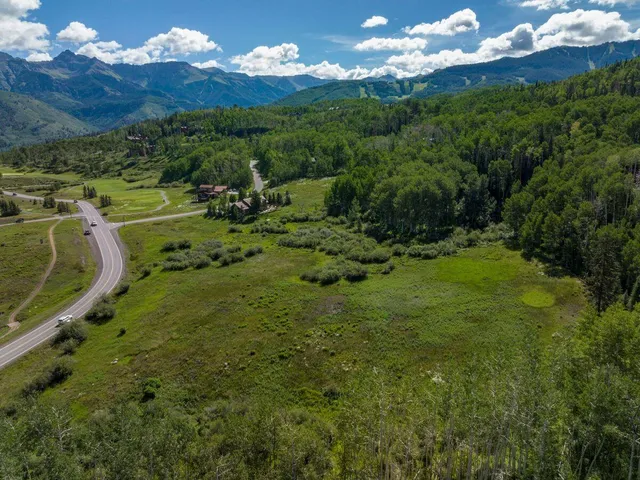 a view of a town with mountains in the background