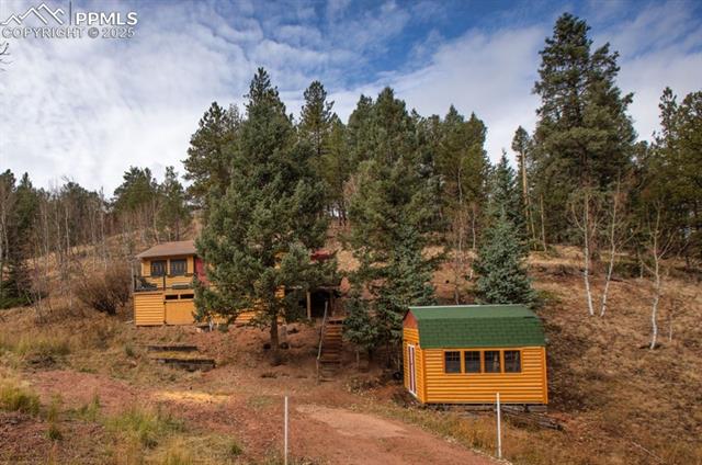 361 Willow Road Divide, CO 80814 - Photo 10 of 27 View of yard with stairway and an outdoor structure