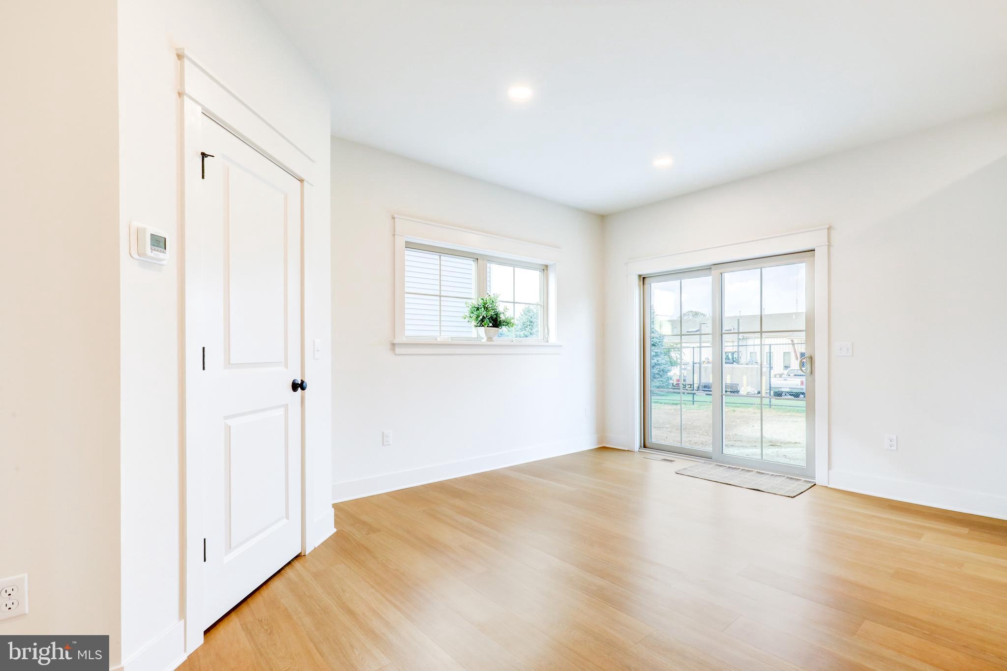218 Parkside Place Lancaster, PA 17602 - Photo 12 of 48 a view of an empty room with wooden floor and a window