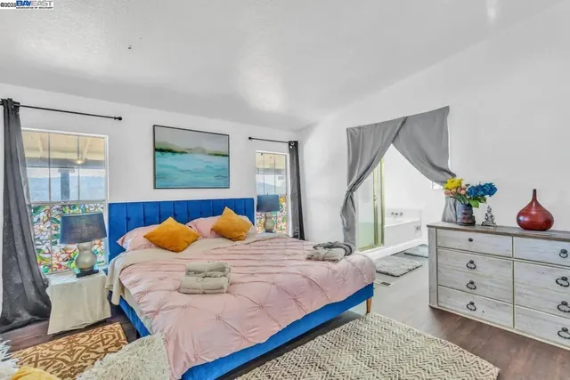 a bedroom with a bed and window