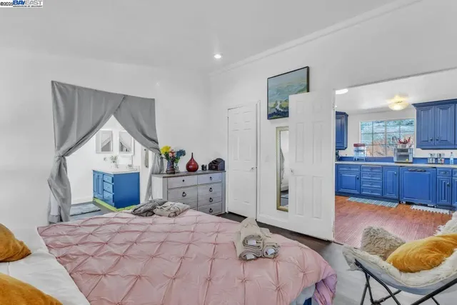 a bed room with a bed mirror and a table