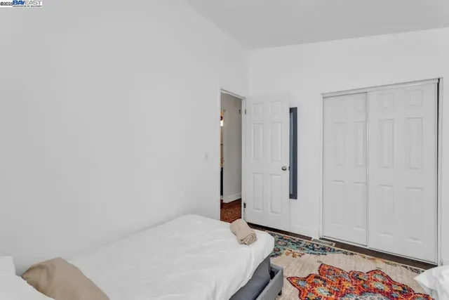 a bedroom with a bed and a dresser