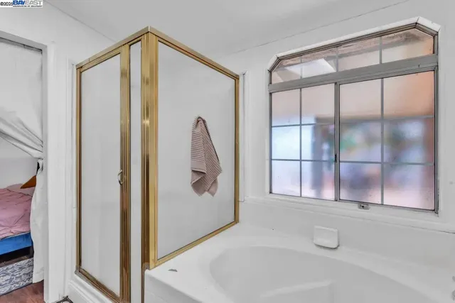 a bathroom with a bathtub and a shower