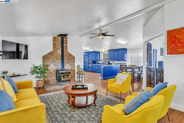 a living room with furniture a fireplace and a flat screen tv
