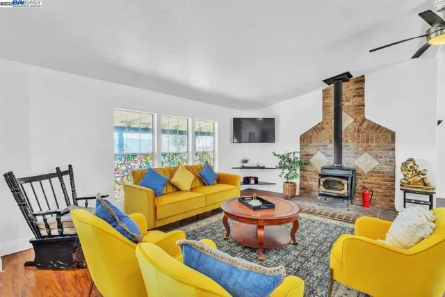 a living room with furniture fireplace and a large window