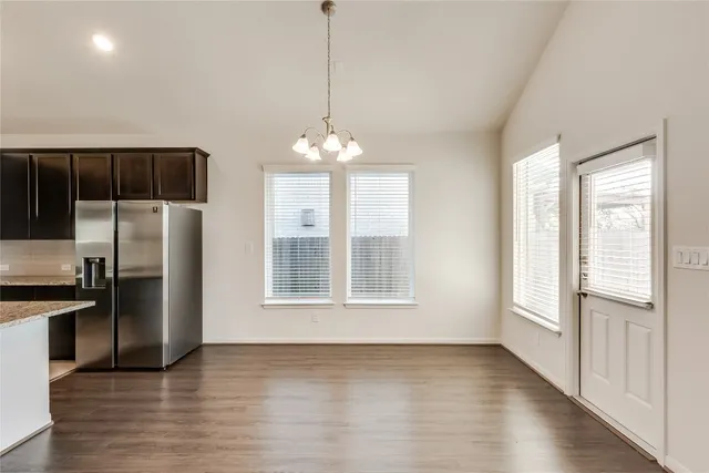 a view of a kitchen with a sink and refrigerator