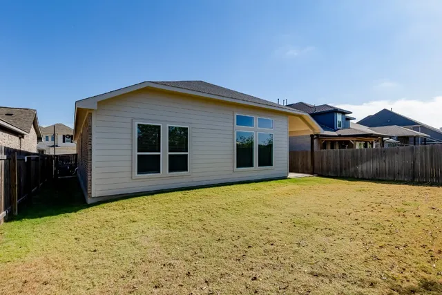 a view of a house with pool and yard