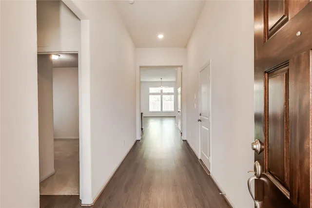 a view of hallway with wooden floor