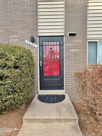 a view of a door with a door and tree