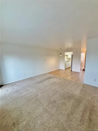 a view of an empty room with a fireplace