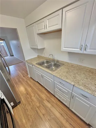 a kitchen with cabinets and window