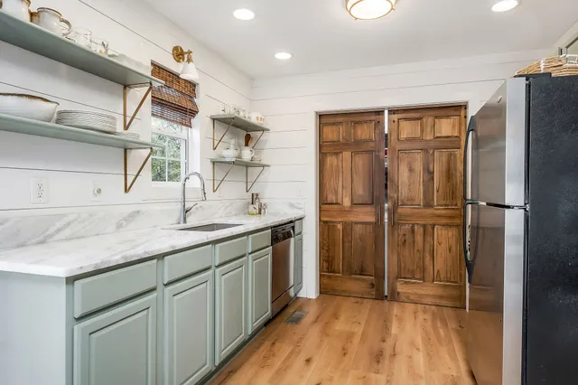 a kitchen with a refrigerator and a sink