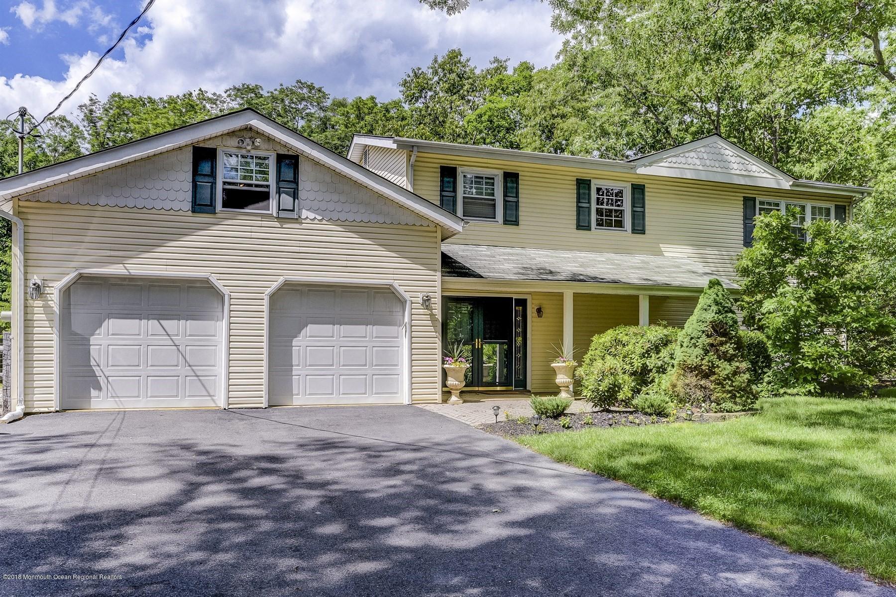 66 Thompson Bridge Road Jackson, NJ 08527 - Photo 2 of 34 a front view of a house with a yard and garage