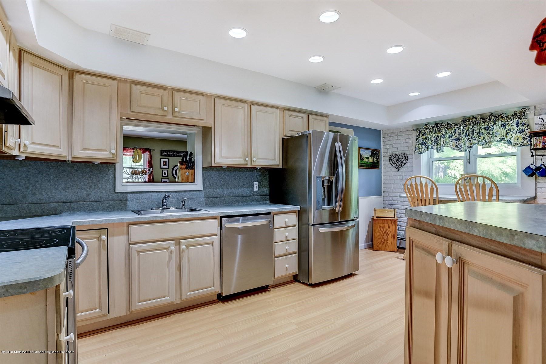 66 Thompson Bridge Road Jackson, NJ 08527 - Photo 15 of 34 a kitchen with stainless steel appliances granite countertop a refrigerator sink and microwave