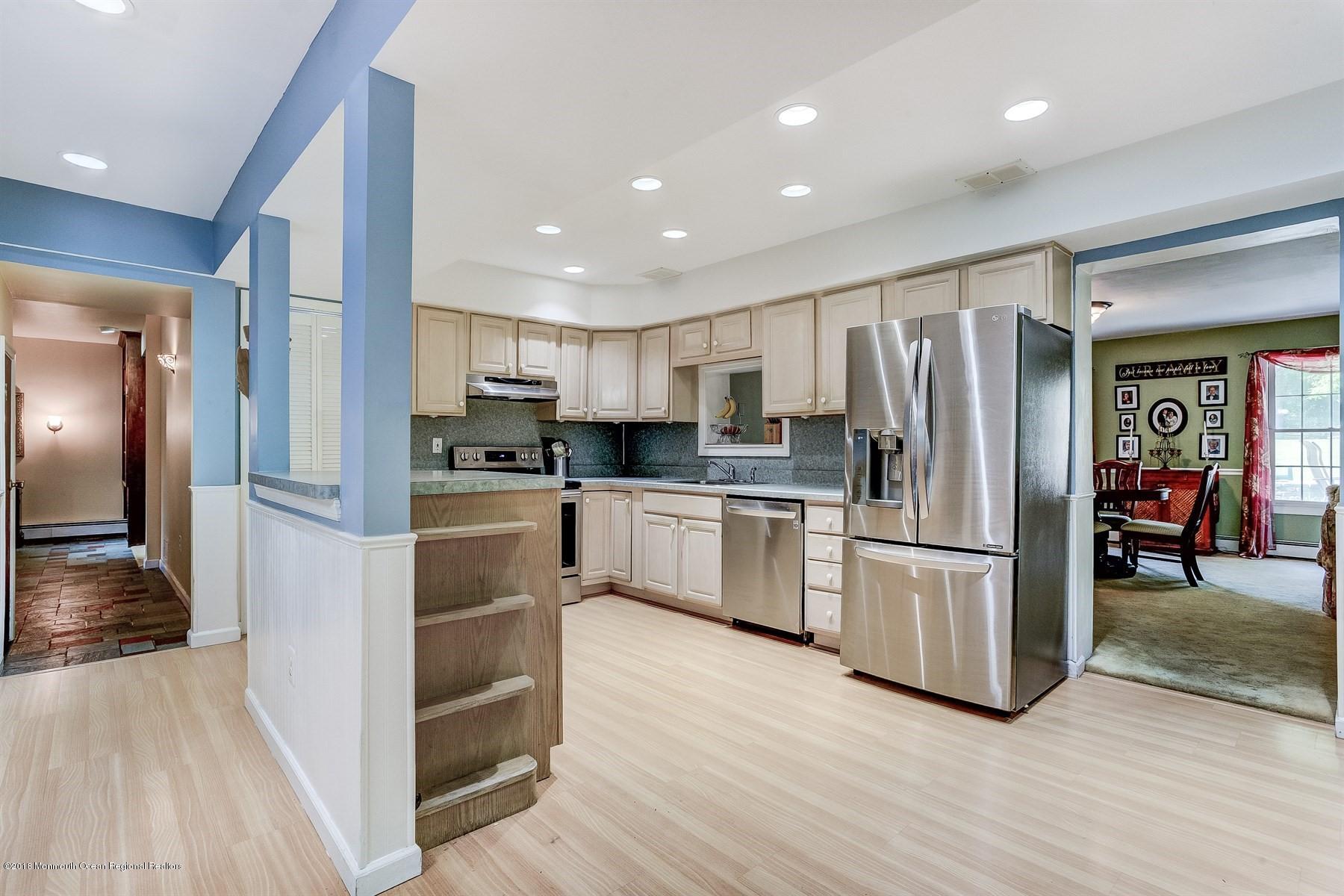 66 Thompson Bridge Road Jackson, NJ 08527 - Photo 16 of 34 a kitchen with white cabinets and stainless steel appliances