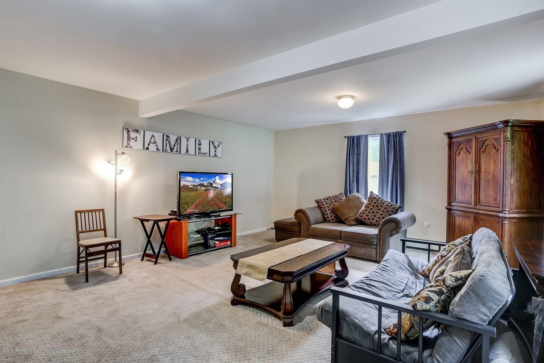 66 Thompson Bridge Road Jackson, NJ 08527 - Photo 20 of 34 a living room with furniture and a flat screen tv