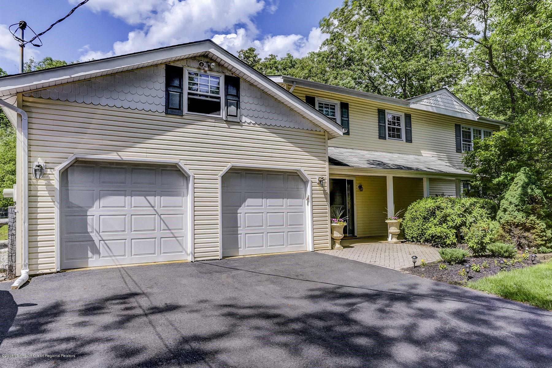 66 Thompson Bridge Road Jackson, NJ 08527 - Photo 3 of 34 a front view of a house with a yard and garage