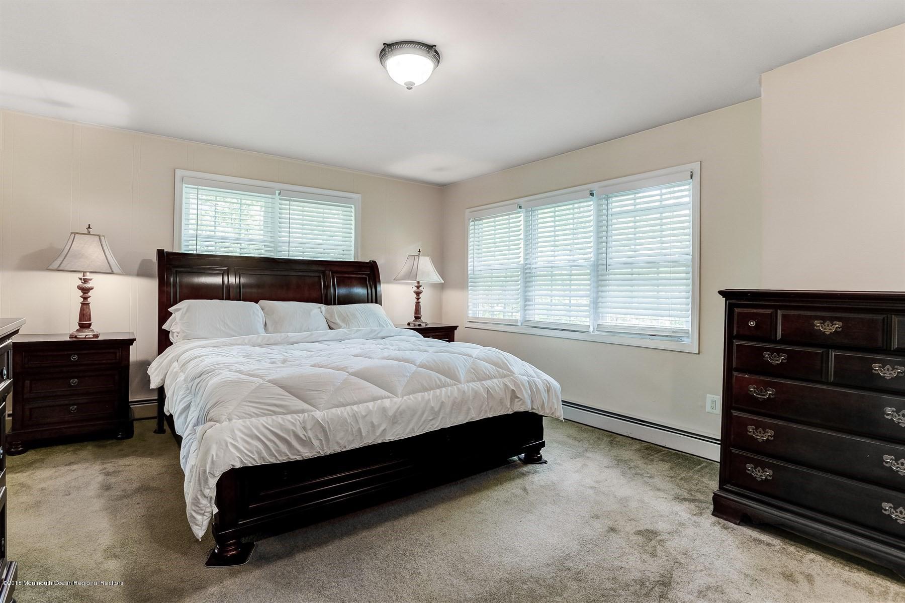 66 Thompson Bridge Road Jackson, NJ 08527 - Photo 23 of 34 a bed sitting in a bedroom next to a window