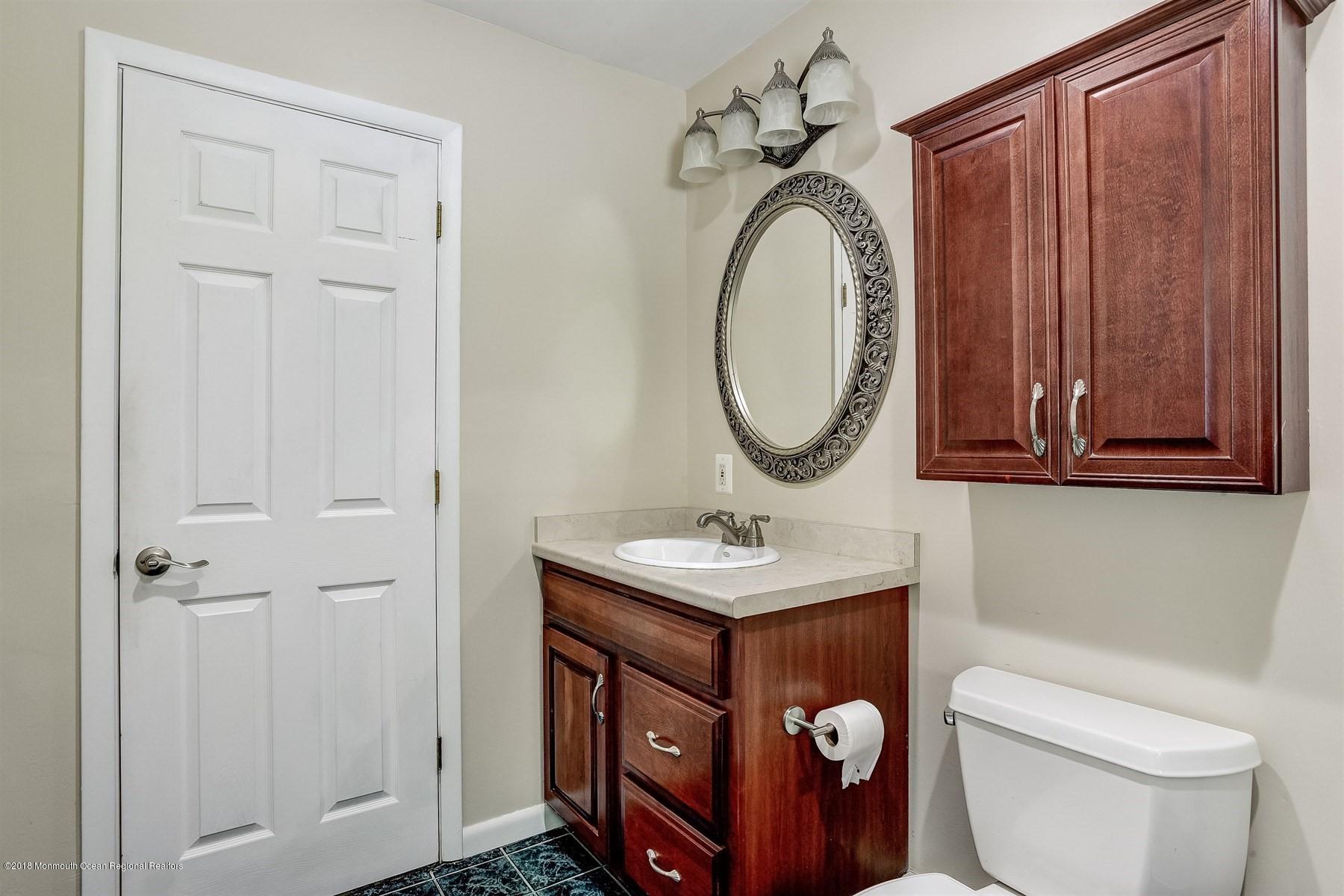 66 Thompson Bridge Road Jackson, NJ 08527 - Photo 25 of 34 a bathroom with a toilet a sink and mirror