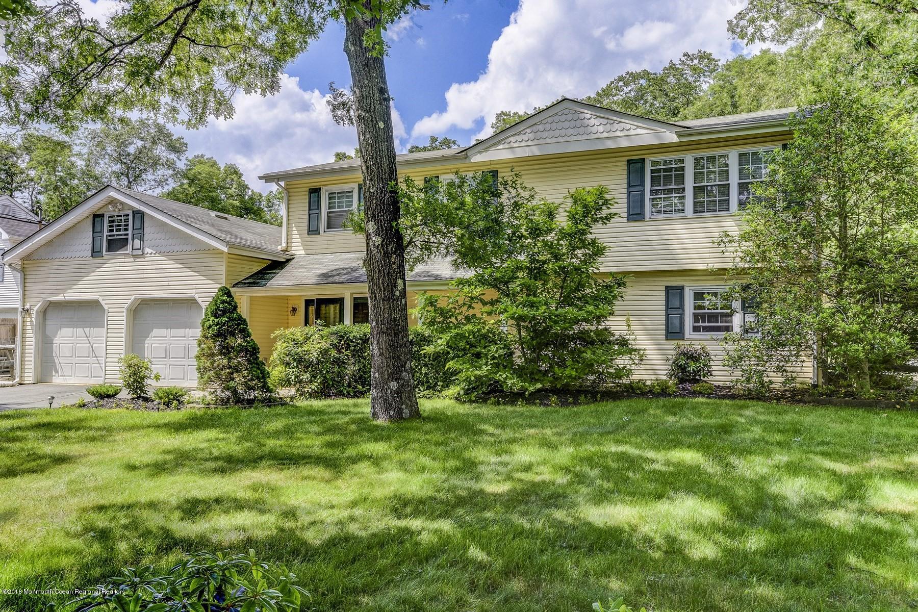 66 Thompson Bridge Road Jackson, NJ 08527 - Photo 4 of 34 a front view of a house with a garden