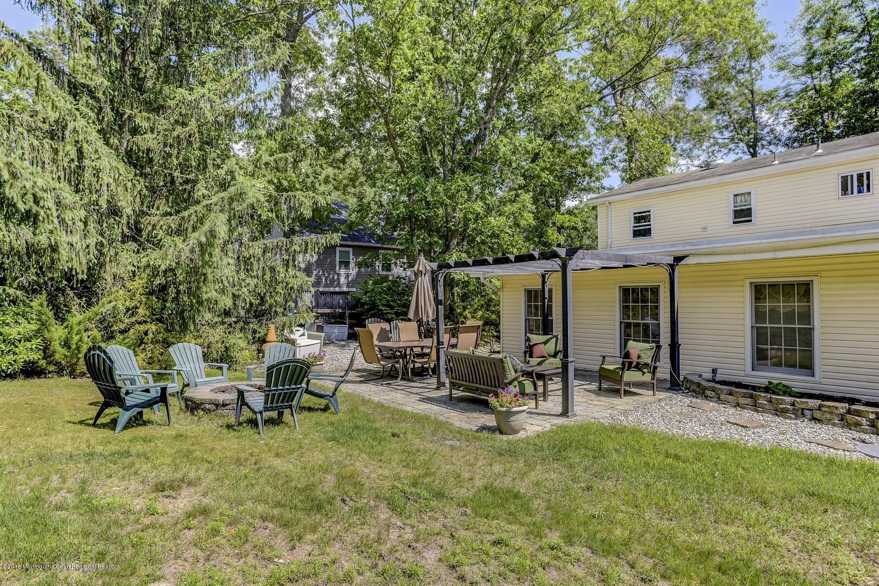 66 Thompson Bridge Road Jackson, NJ 08527 - Photo 31 of 34 a view of a patio with table and chairs a barbeque with wooden fence