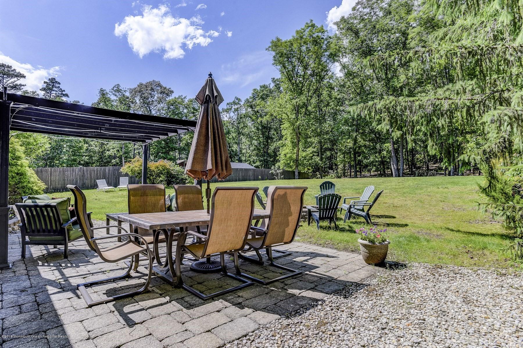 66 Thompson Bridge Road Jackson, NJ 08527 - Photo 33 of 34 a view of a patio with a table chairs and a backyard