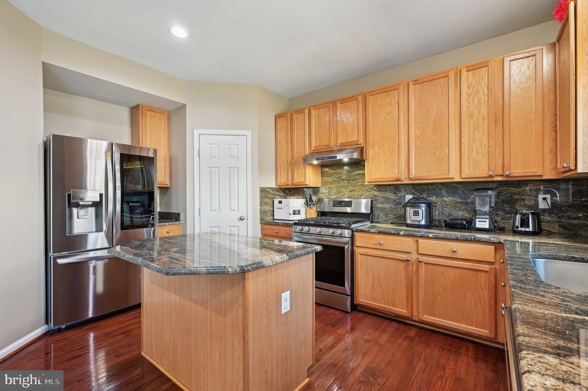 9552 Chaton Road Laurel, MD 20723 - Photo 12 of 53 a kitchen with stainless steel appliances granite countertop a refrigerator a stove and a sink