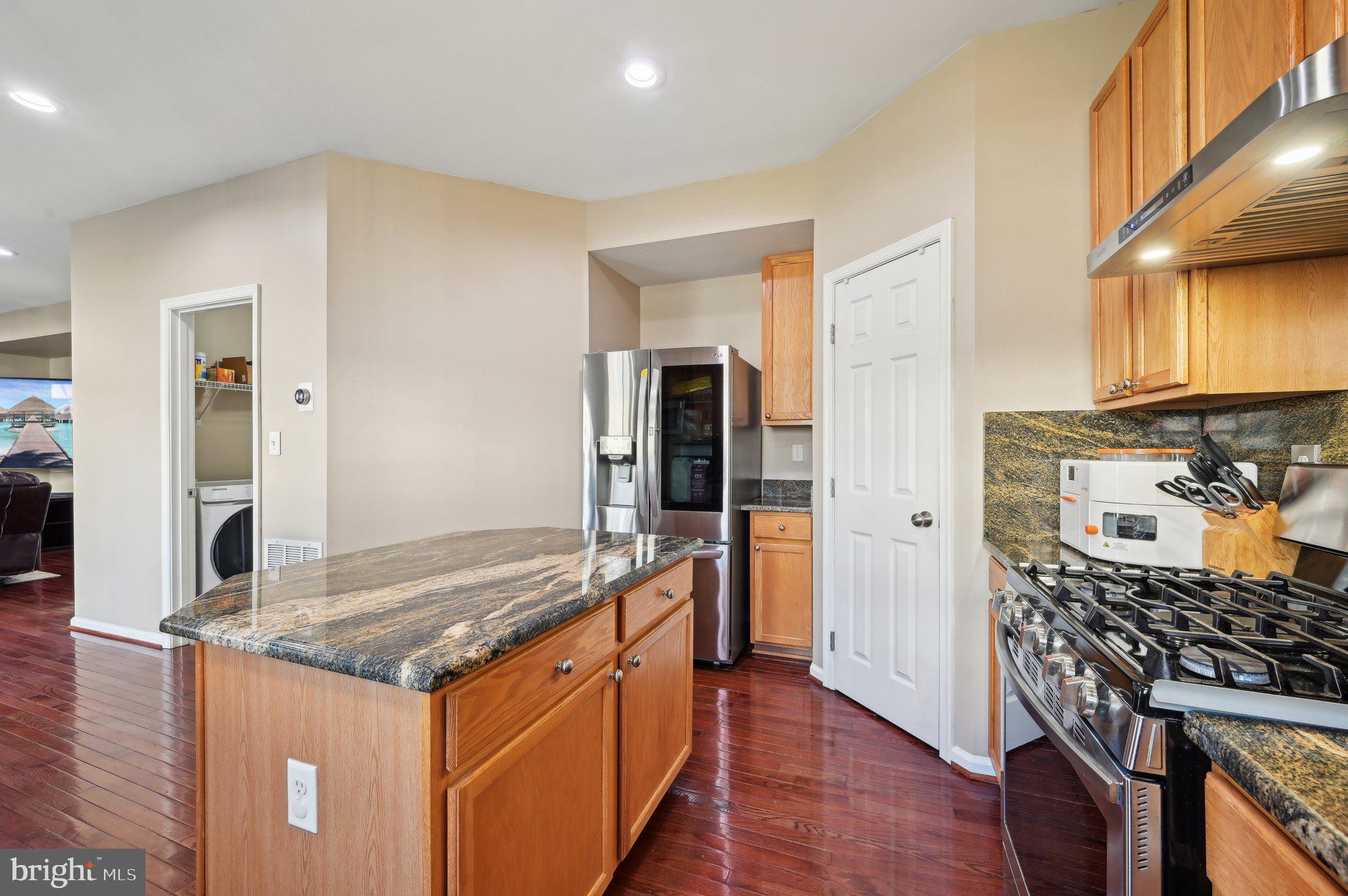9552 Chaton Road Laurel, MD 20723 - Photo 13 of 53 a kitchen with granite countertop a sink and a stove top oven