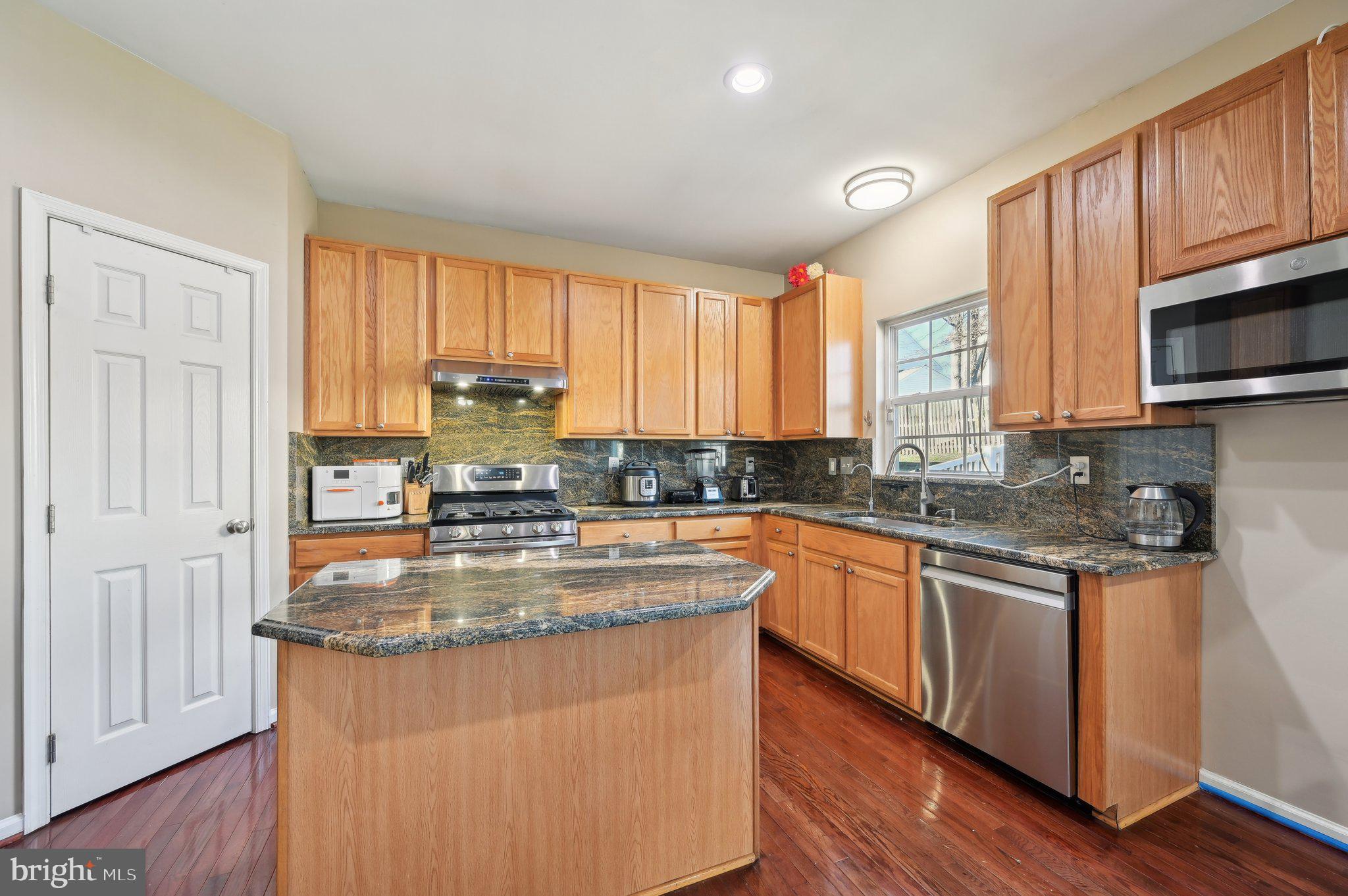 9552 Chaton Road Laurel, MD 20723 - Photo 15 of 53 a kitchen with stainless steel appliances granite countertop a stove a sink and a microwave
